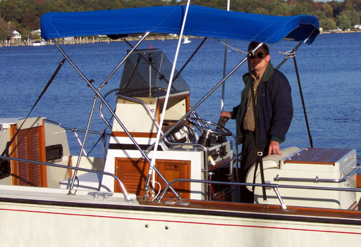 [Photo: 1983 Whaler 25 Outrage Cuddy with Peter Ferguson at Helm]