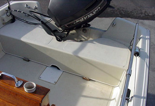 [Photo: Boston Whaler Montauk interior with molded cover in stern]
