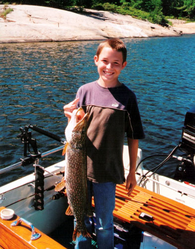 Photo: 1974 Whaler 17 Montauk; young boy with large Northern Pike.