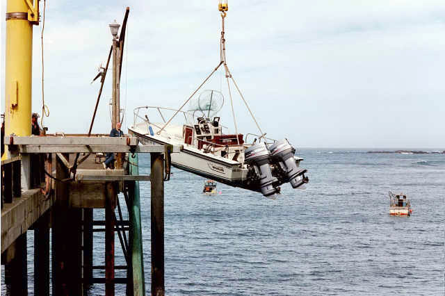 Photo: 1989 Whaler 18-Outrage being lowered from pier