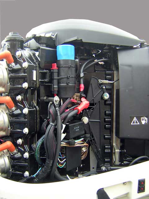 [Photo: Evinrude 225-HP E-TEC Outboard starboard side with cowling and shroud removed.]