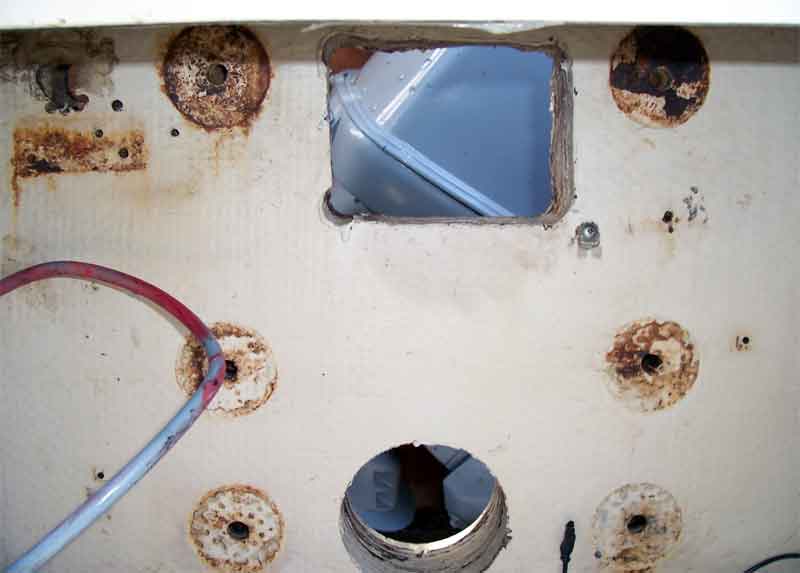 Photo: View of transom from inboard side showing large holes in transom.