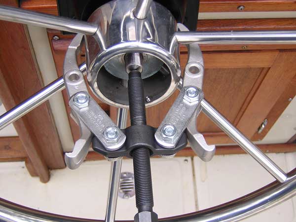 [Photo: Gear puller ready to remove wheel]