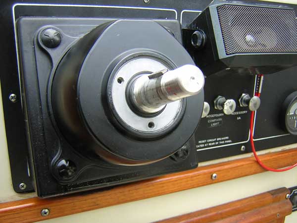 [Photo: Close-up of helm pump showing seal cover plate removed]